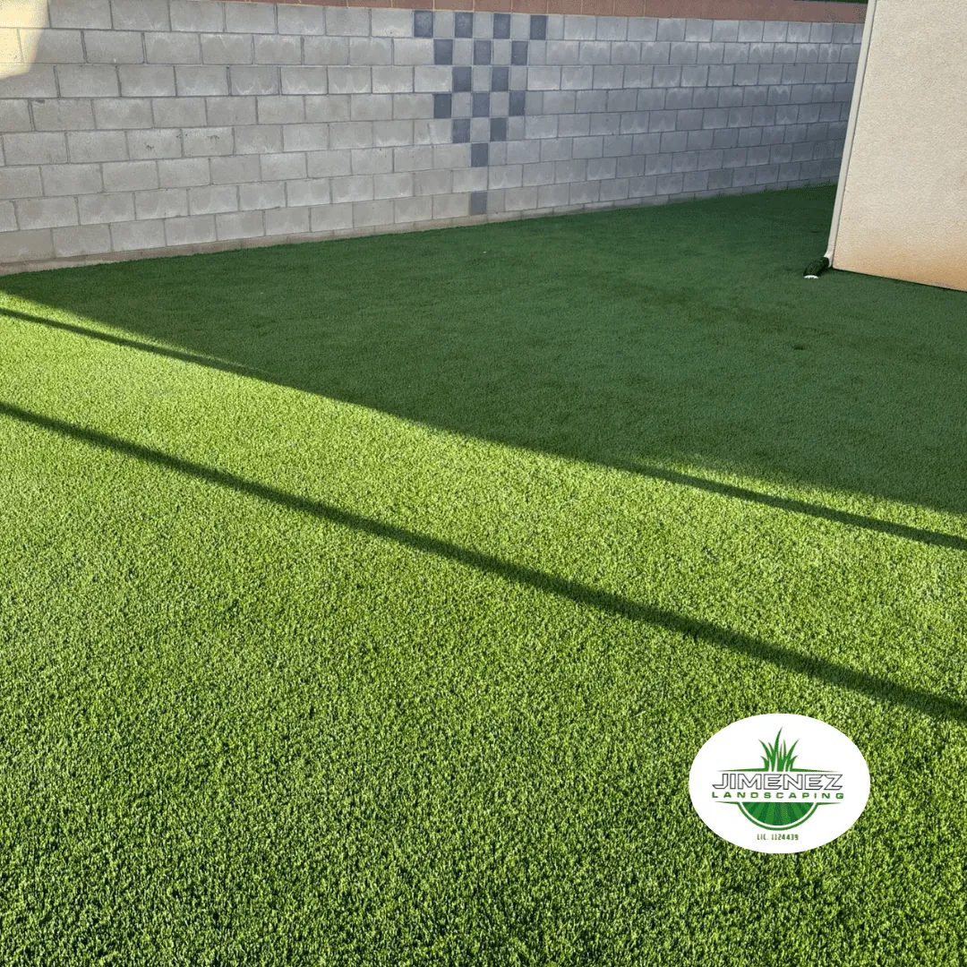 Artificial turf installation in a residential yard, showcasing vibrant green grass and a clean, well-maintained outdoor space in Bakersfield.